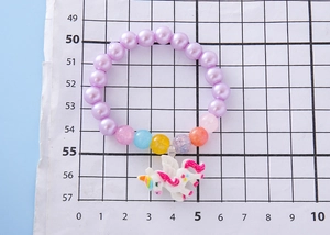 Bracelet enfant perles violettes et licorne sur papier millimétré pour dimension