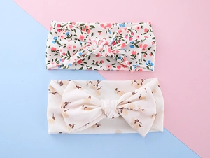 Detail of floral baby headbands featuring double-layer bows and ribbed texture fabric