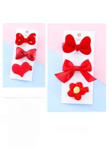 Detailed set of red festive New Year hair clips with bows and plush hearts for girls