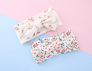 Close-up of baby floral headband set with big bow and wide band in soft knit fabric