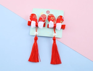 Detail of red New Year hair clips with white bows, rabbit ears, long tassels and pearls