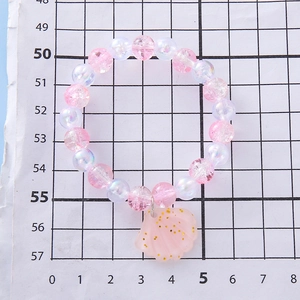 Girl's pink beaded bracelet with iridescent white pearls and a glitter shell pendant