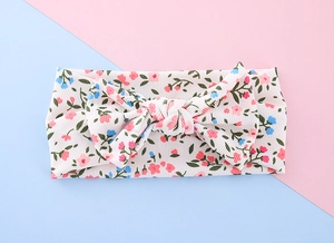 Detailed close-up of ribbed floral baby headband with a charming decorative bow tie