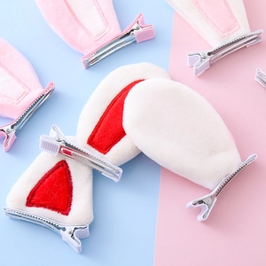 Cute plush rabbit ear hair clips for kids in assorted colors on a pastel background