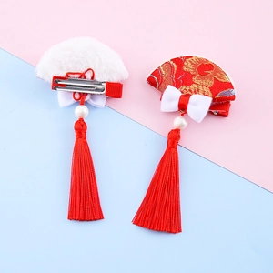 Traditional Chinese New Year hair clips with red tassels and golden flower embroidery