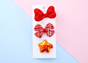 Detail of red velvet plaid bows and star hair clips set on a display card