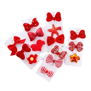 Red festive children's hair clip set with plush bows and knitted hearts for New Year