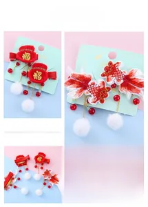 Detailed view of Chinese New Year red koi fish and lucky bag hair clips for kids