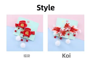 Detail of embroidered koi fish and fortune bag hair clips with red tassels for New Year