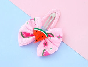 Detailed view of pink ribbon bow hair clip with watermelon centerpiece for girls