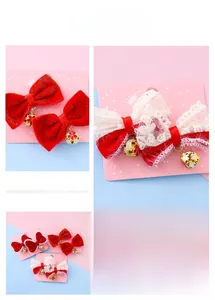 Detail view of red velvet bow hair clip with intricate golden floral bell pendant charms