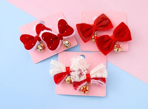 Detailed set of red velvet and lace bow hair clips with golden floral bells for kids