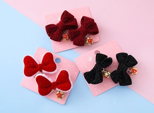 Detailed set of 3 velvet hair bows with glitter finish and red floral bell pendants