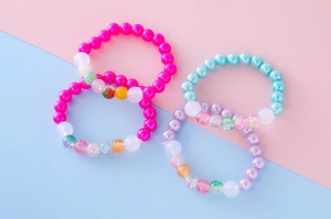 Detailed view of colorful beaded bracelets with cute resin pearls for girls