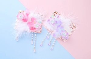 Detail of handmade Chinese style hair clips with silk flowers and feather tassels