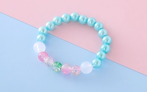 Close-up of pastel beaded bracelet with light blue faux pearls and pink cracked beads