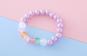 Detail of colorful beaded bracelet with purple pearls and vibrant crackle beads
