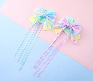 Macro shot of colorful satin princess hair bows with long elegant ribbon tassels