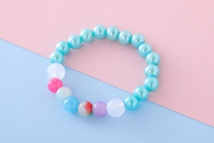 Detail view of a colorful beaded girl's bracelet featuring cracked and blue pearl beads