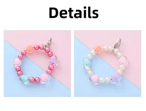 Close-up of handmade beaded charms with colorful pearls and acrylic heart shapes