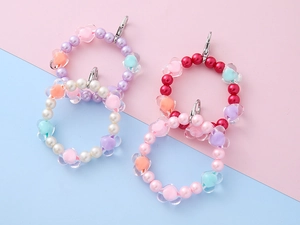 Close-up of colorful beaded heart charms for bags and phones with lobster clasps