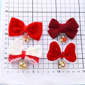 Red bow hair clips for kids featuring golden bell pendants and flower details