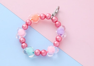 Close-up of colorful beaded chain with pearlescent pink beads and transparent heart charms