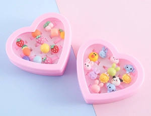 Detail of 12pcs kids cartoon resin rings in heart-shaped pink storage boxes