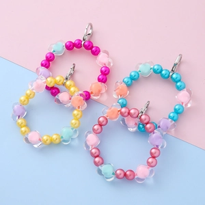 Colorful beaded phone wrist straps with pearls and heart charms in four pastel colors