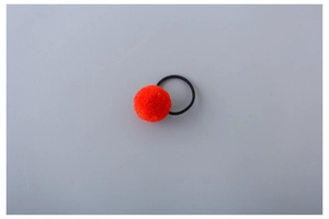 Close-up of a vibrant orange pompom hair tie with a black high-elastic rubber band
