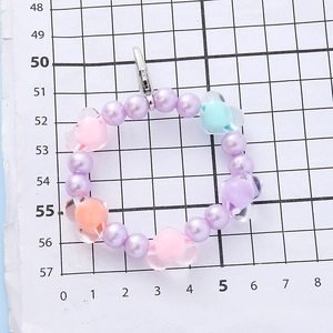 Sweet purple beaded bracelet with colorful heart charms and silver lobster clasp detail