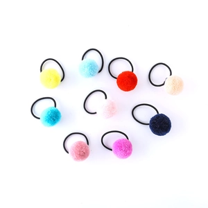 Set of nine colorful fuzzy pom pom hair ties with high elastic black bands for girls