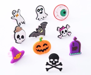 Dettaglio macro di ciondoli Halloween in PVC con zucche, pipistrelli e teschi colorati