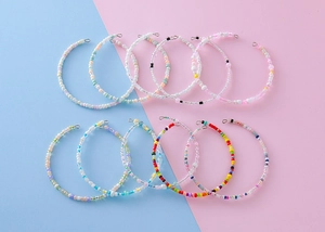Detailed flat lay of colorful seed bead bracelets in vibrant multi-color rainbow patterns