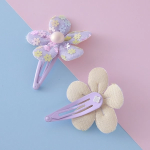 Sweet children floral hair clips set with colorful sequins and pearls on pastel background