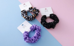 Three-piece Halloween scrunchie set with spooky prints and sparkling sequins on display