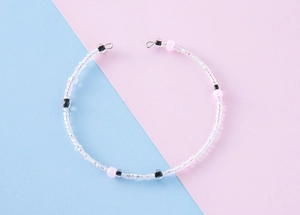Detailed shot of handmade colorful bead necklace with transparent and pink acrylic beads