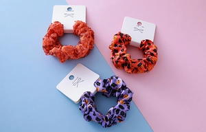 Three-piece Halloween hair scrunchies set with orange sequins and pumpkin bat prints