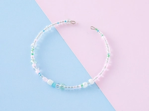 Detail of colorful handmade beaded bracelet with metallic memory wire and hook closure