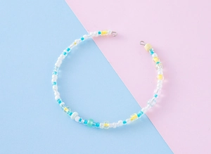Macro detail of colorful Y2K handmade beaded necklace with macaron glass beads
