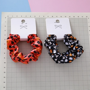 Halloween ghost and pumpkin print hair scrunchies set on measurement mat for sizing