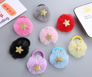 Detailed view of colorful mesh flower hair ties with glitter star accents for kids