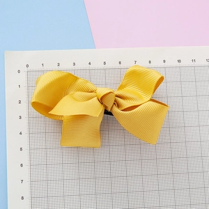 Pince à cheveux enfant avec nœud en ruban jaune gingembre et design double couche