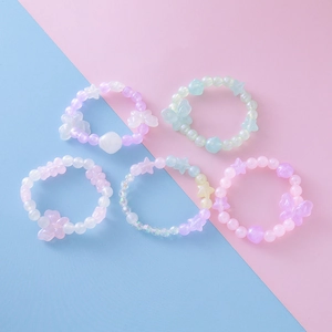 Set de cinq bracelets pour enfants aux perles macaron avec breloques papillon et étoile
