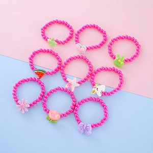 Detail of colorful resin beaded bracelets with cute cartoon rabbit and flower pendants