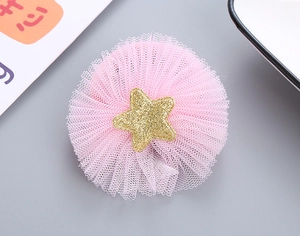 Detailed macro view of pink mesh flower hair tie with golden glitter star center ornament