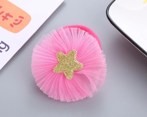 Detail of pink mesh ruffle hair tie featuring a sparkling golden glitter star charm