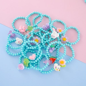 Detailed close-up of colorful resin beads bracelets featuring cute rabbit and fruit charms