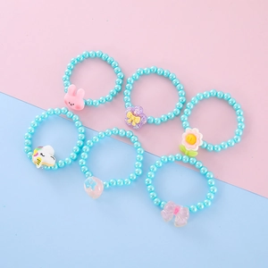 Detail view of 6-piece beaded children bracelets set with cute resin animal and floral charms