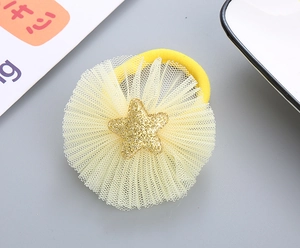 Detail view of yellow mesh hair tie featuring a glittery star and high-elastic band